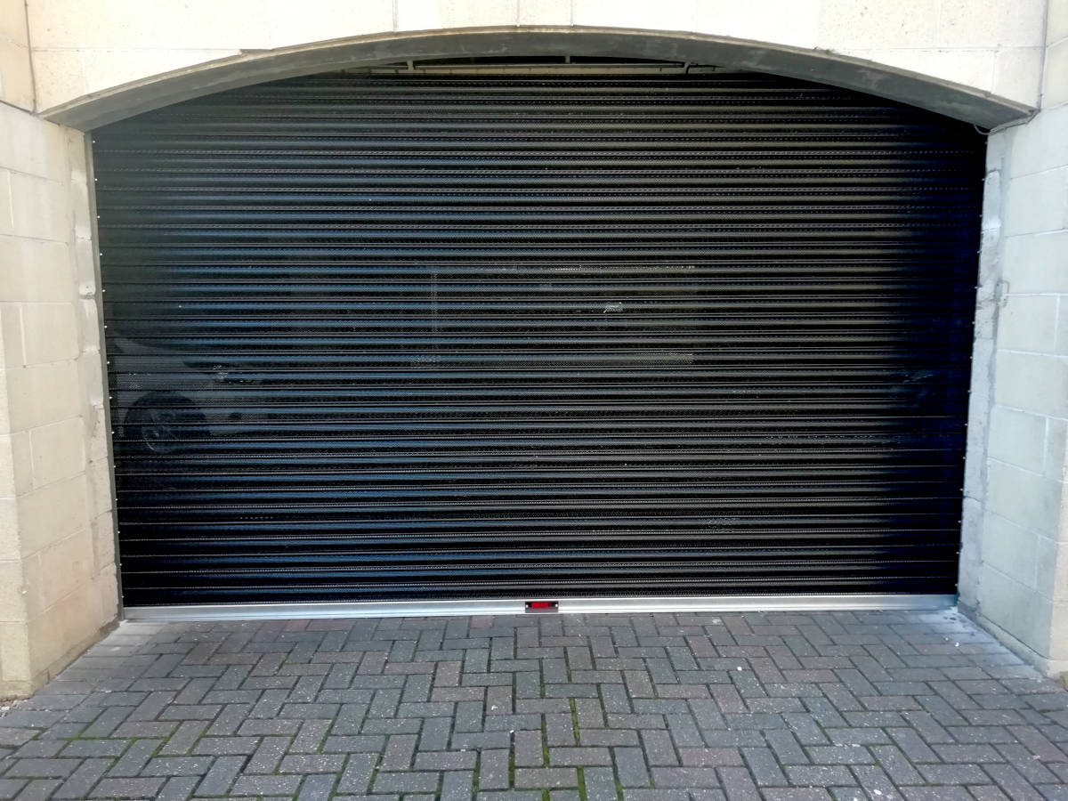 Image of communal-roller-perforated-garage-door-exterior-001.jpg 2018-10-23 - Perforated Security Door on Communal Garage in Newport