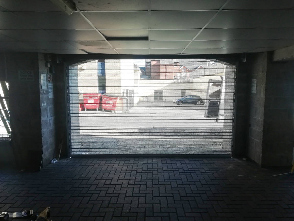 Image of communal-roller-perforated-garage-door-interior-001.jpg 2018-10-23 - Perforated Security Door on Communal Garage in Newport
